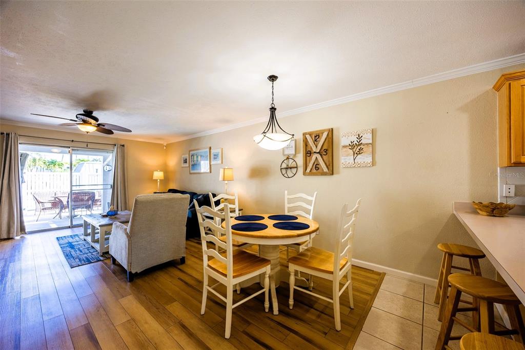 6777 Winkler Road, Unit 150 Fort Myers, FL 33919 - Photo 8 of 48 a dining room with furniture and wooden floor