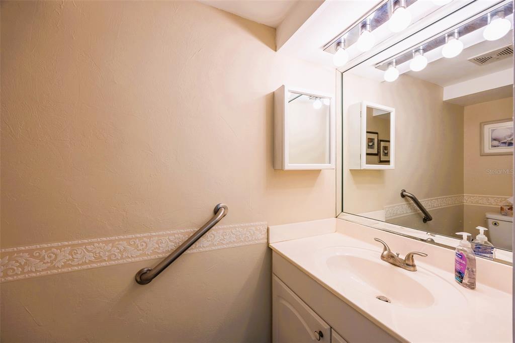 6777 Winkler Road, Unit 150 Fort Myers, FL 33919 - Photo 9 of 48 a bathroom with a sink and a mirror