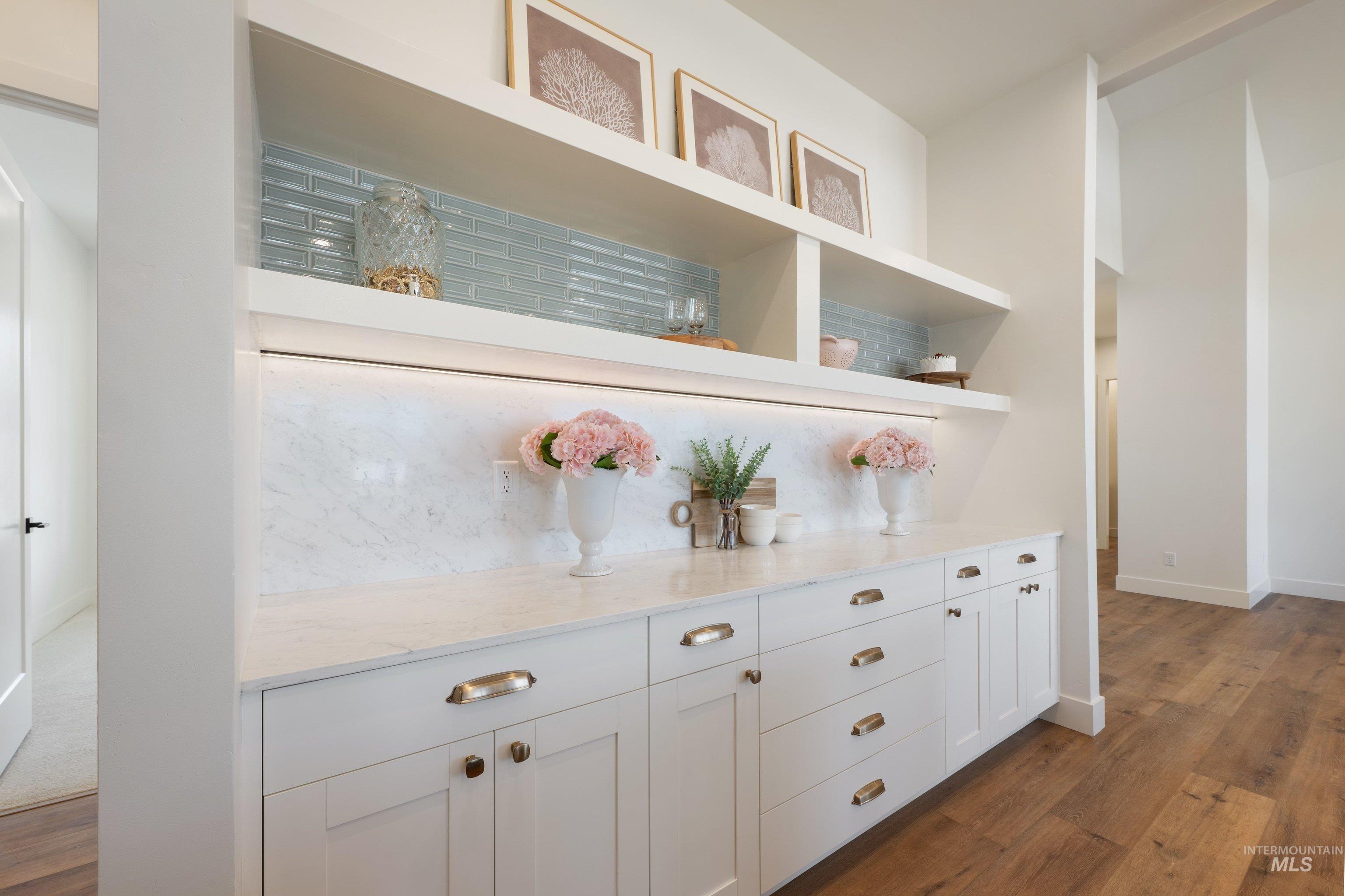 24821 Ardmore Court Caldwell, ID 83607 - Photo 19 of 43 Built-in cabinetry with cup pulls and knobs, featuring a solid surface countertop and backsplash