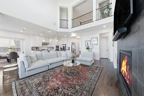 a living room with furniture a rug and a fireplace