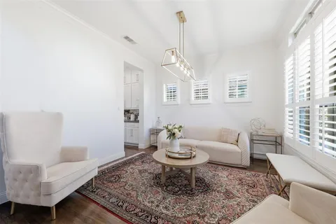 a living room with furniture a rug and a window