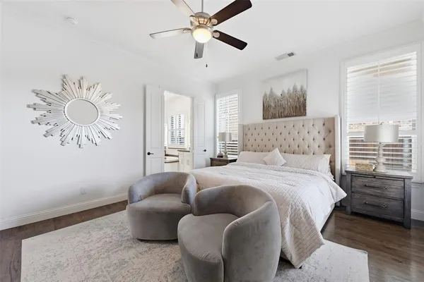 a bedroom with a bed couch and window