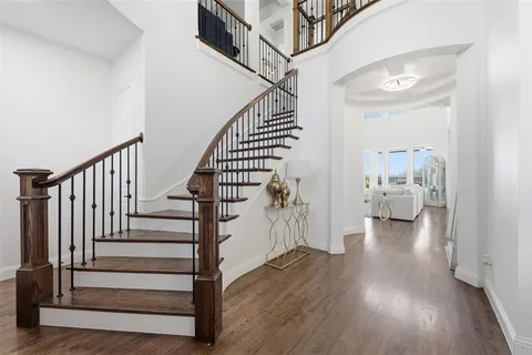 a view of entryway and hall with wooden floor