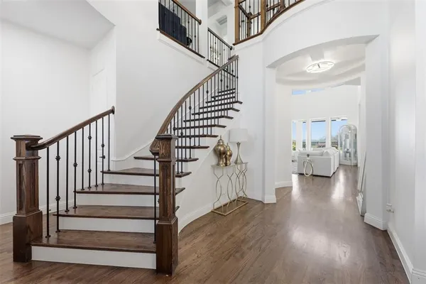 a view of entryway and hall with wooden floor