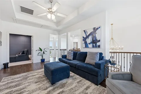 a living room with furniture and a chandelier
