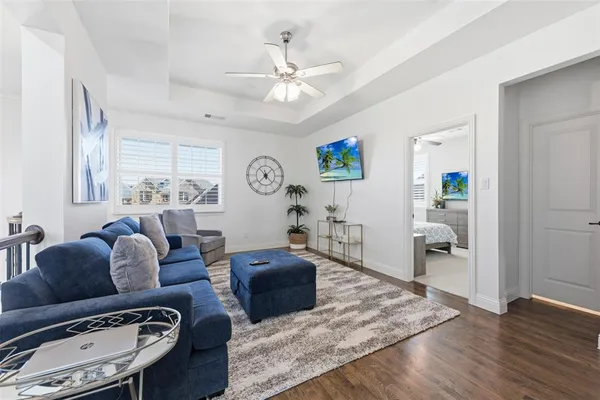 a living room with furniture and wooden floor