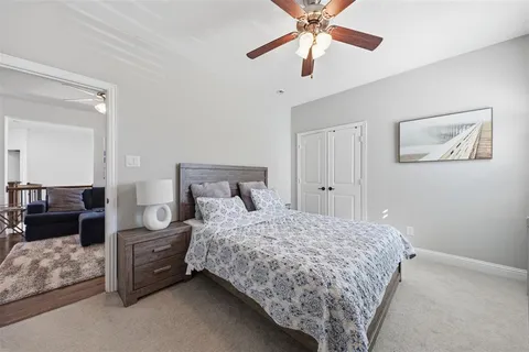 a bedroom with a bed and ceiling fan