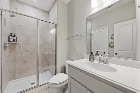 a bathroom with a sink toilet and shower