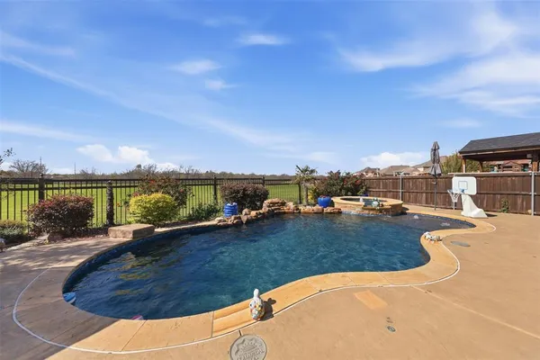 a view of a swimming pool and an outdoor seating