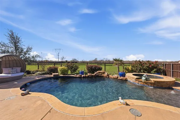 an outdoor space with furniture and a garden