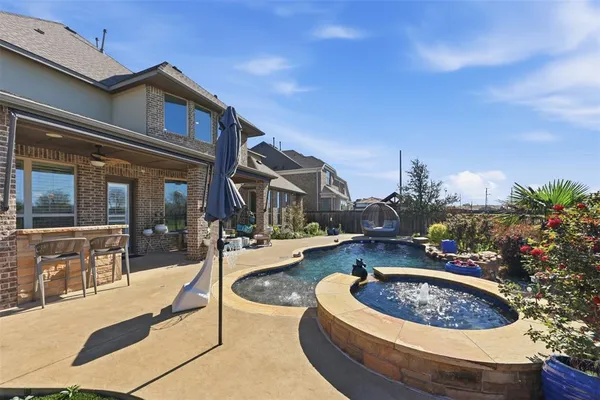 a view of a house with swimming pool and sitting area