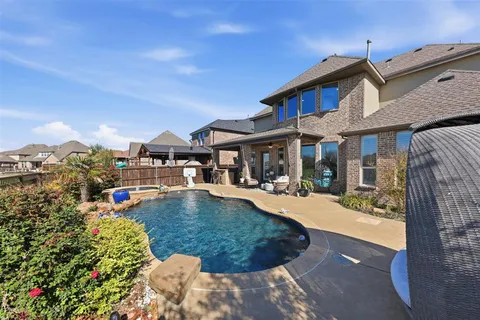 a view of a house with swimming pool and sitting area