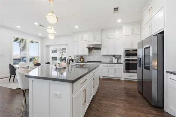 a kitchen with counter top space a sink stainless steel appliances and cabinets
