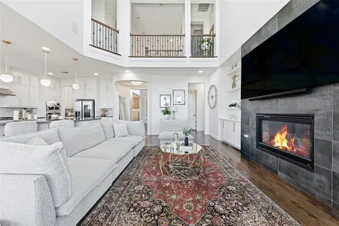 a living room with furniture a flat screen tv and a fireplace