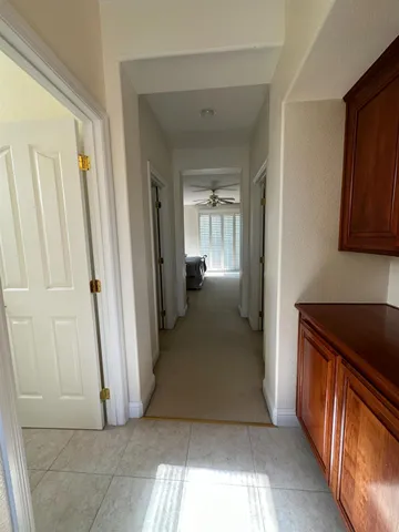a view of a hallway view with wooden floor and staircase