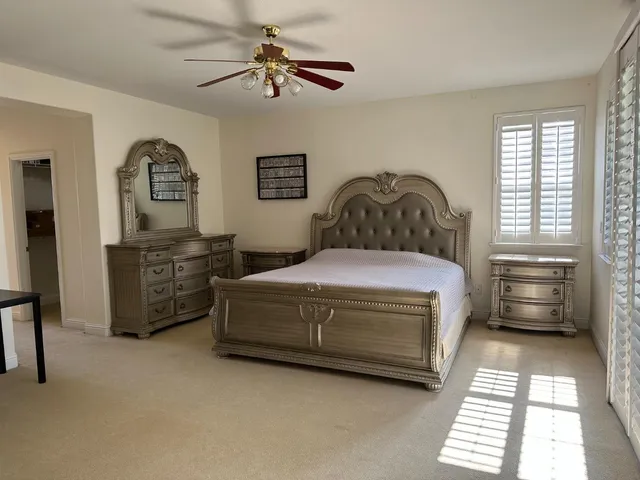 a bedroom with a bed dresser and a window