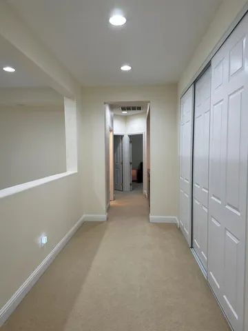 a room with a bed and a chandelier fan