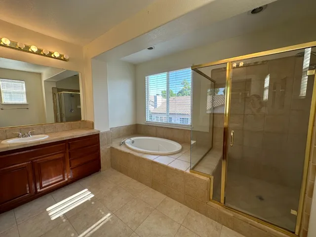 a bathroom with a granite countertop sink a toilet and shower