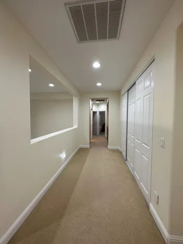 a spacious bathroom with a granite countertop sink and a mirror