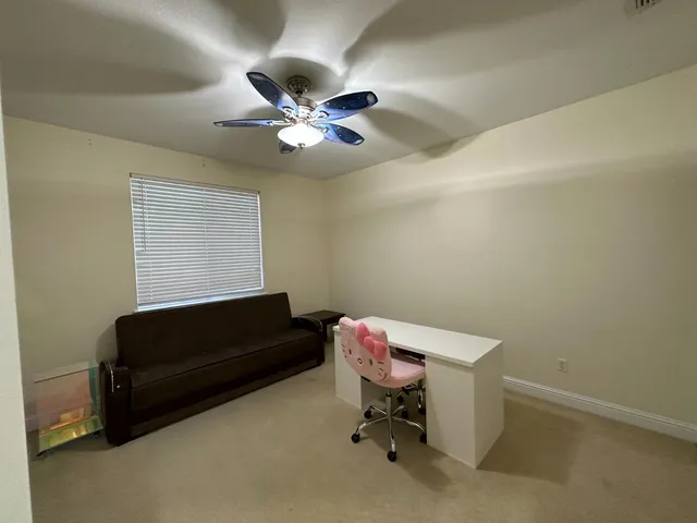 a spacious bedroom with a bed and a chandelier