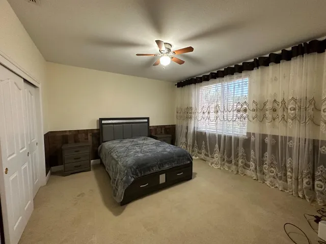 a bathroom with a granite countertop bathtub shower and toilet