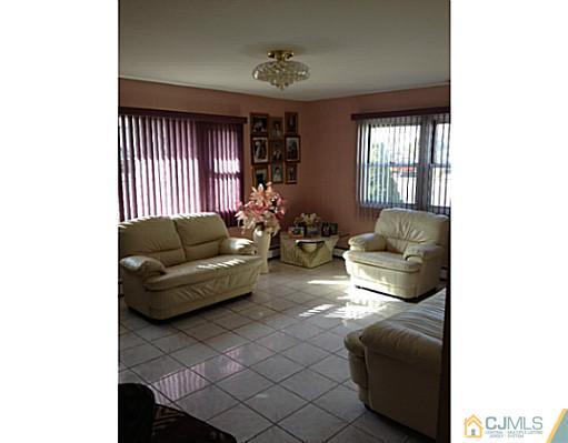 171 Winthrop Road Edison, NJ 08817 - Photo 3 of 13 a living room with furniture and a window