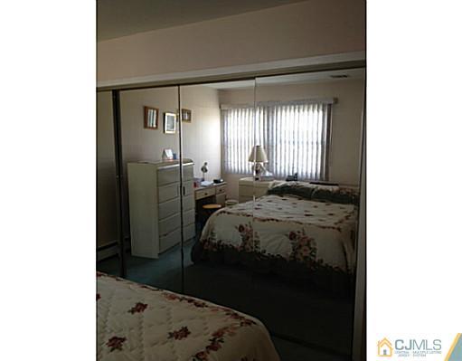 171 Winthrop Road Edison, NJ 08817 - Photo 7 of 13 a bedroom with a bed and a window