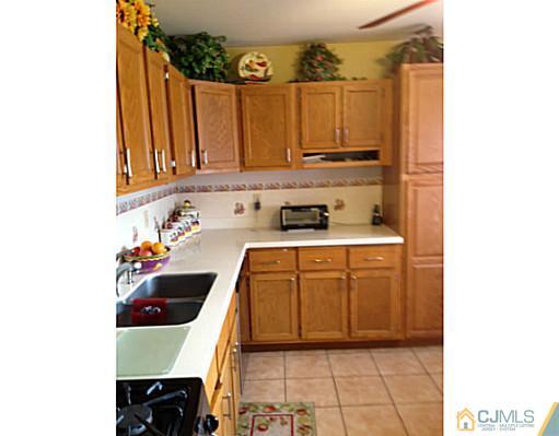 171 Winthrop Road Edison, NJ 08817 - Photo 8 of 13 a kitchen with a sink a stove and cabinets