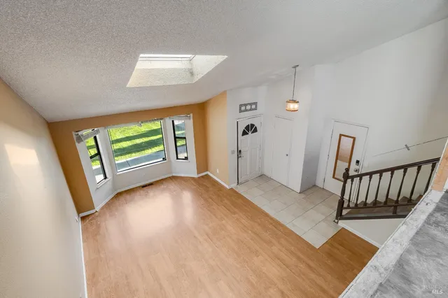 a kitchen with stainless steel appliances granite countertop a sink a stove cabinets and wooden floor