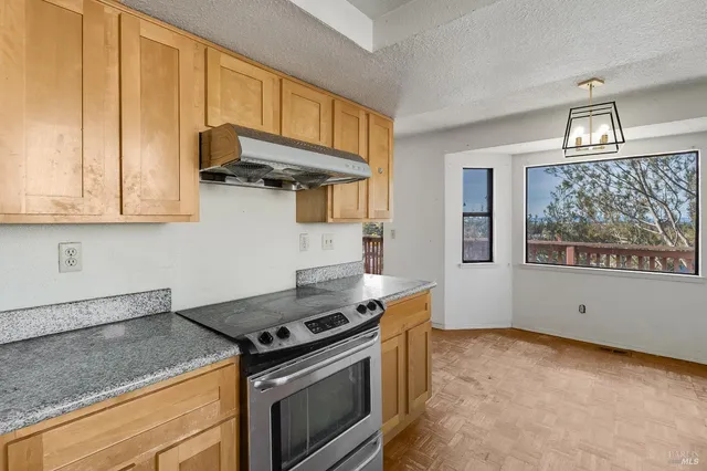 an empty room with windows and painted walls