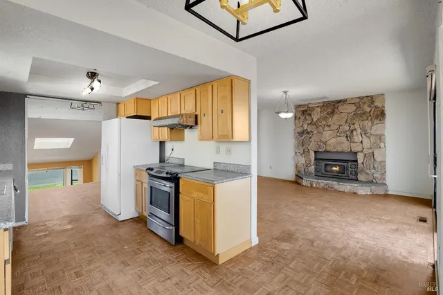 an empty room with a fireplace and fan