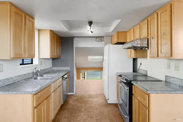 an empty room with windows and chandelier