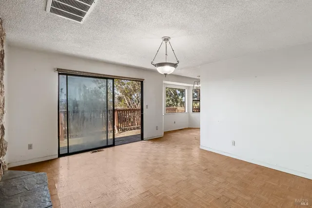 an empty room with windows and closet