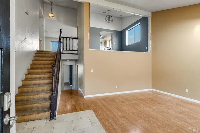 a view of a hallway with entryway wooden floor and front door