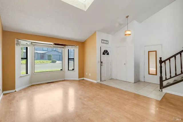 a view of staircase with wooden floor and a chandelier