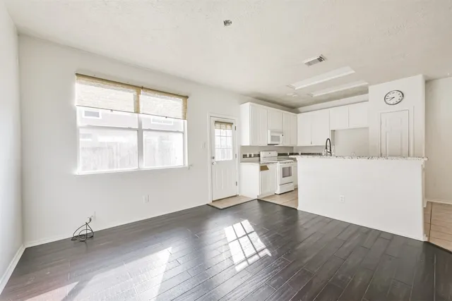 a view of a kitchen with wooden floor