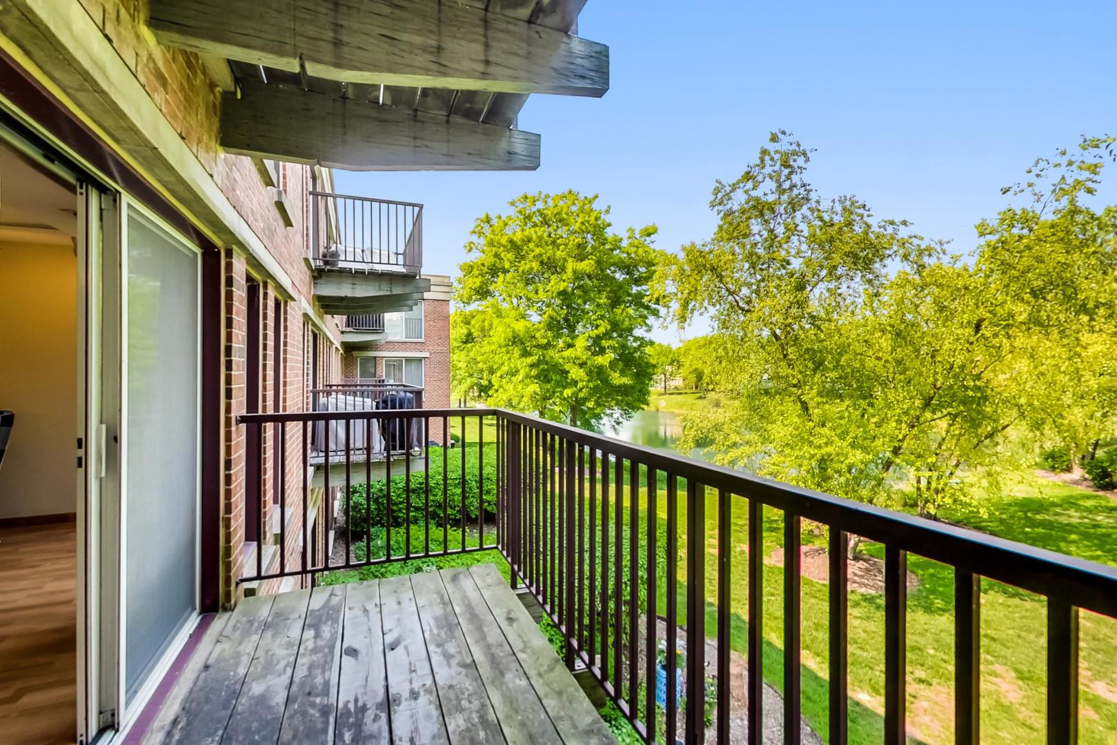 351 Kelburn Road, Unit 213 Deerfield, IL 60015 - Photo 23 of 37 a view of a balcony with wooden floor