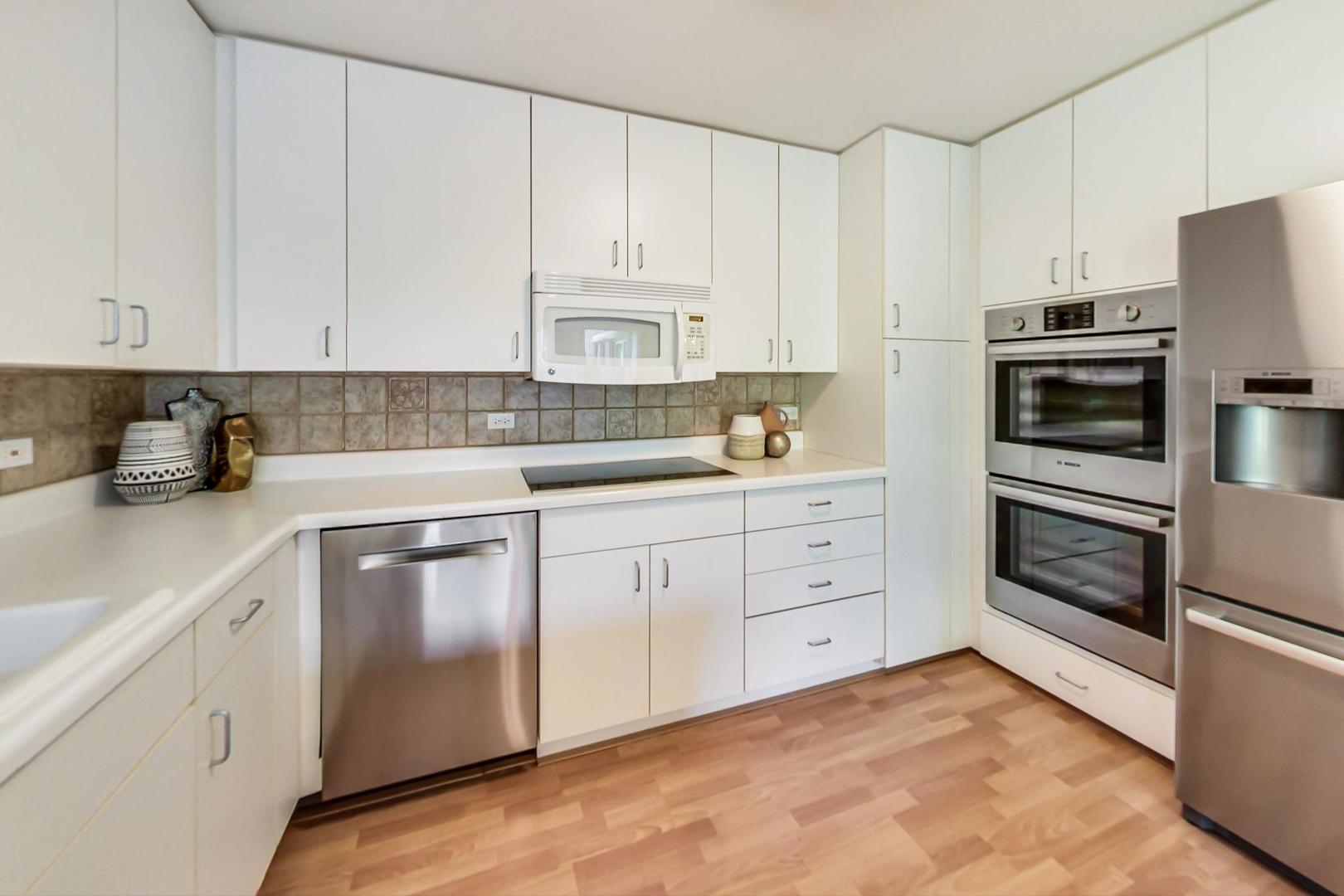 351 Kelburn Road, Unit 213 Deerfield, IL 60015 - Photo 8 of 37 a kitchen with cabinets appliances and a counter space