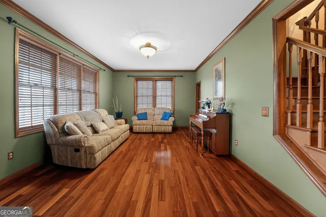 a view of a dining room with furniture window and wooden floor