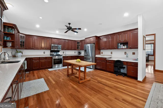 a living room with dining room and wooden floor