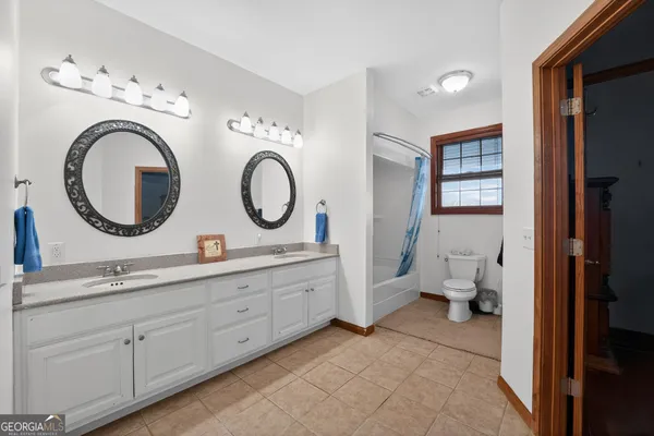 a view of a hallway with wooden floor and stairs