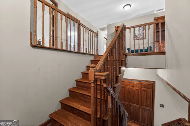 a living room with furniture a flat screen tv and a table