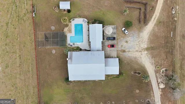 an aerial view of a house with outdoor space