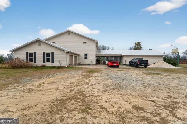 a living room with furniture a flat screen tv and a floor to ceiling window
