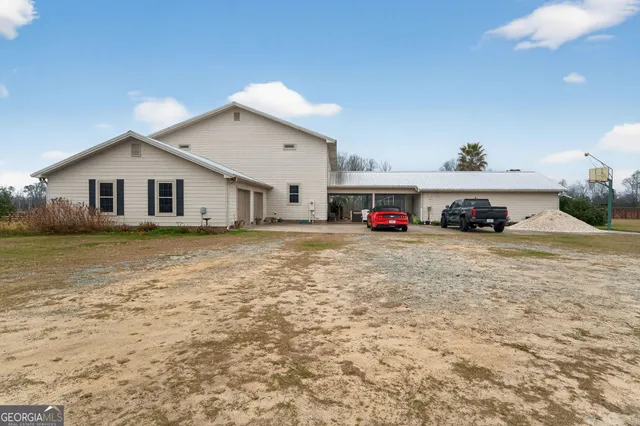 a living room with furniture a flat screen tv and a floor to ceiling window