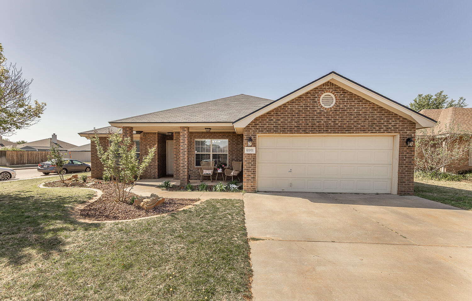 a front view of a house with a garden and yard