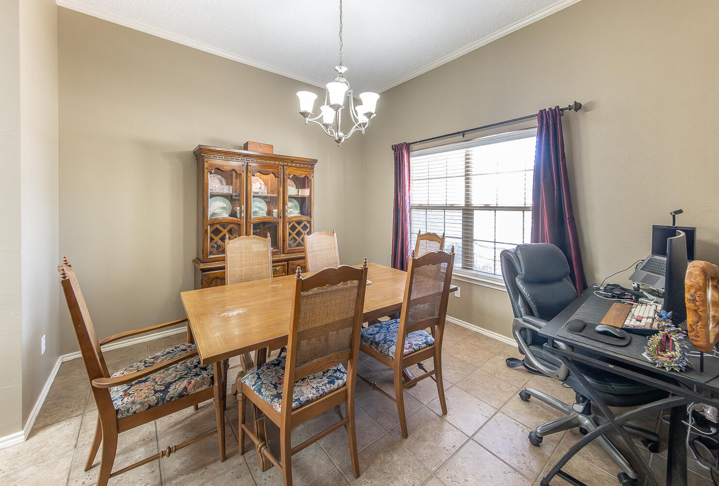 6901 9th Street Lubbock, TX 79416 - Photo 20 of 27 a view of a dining room with furniture a chandelier and wooden floor