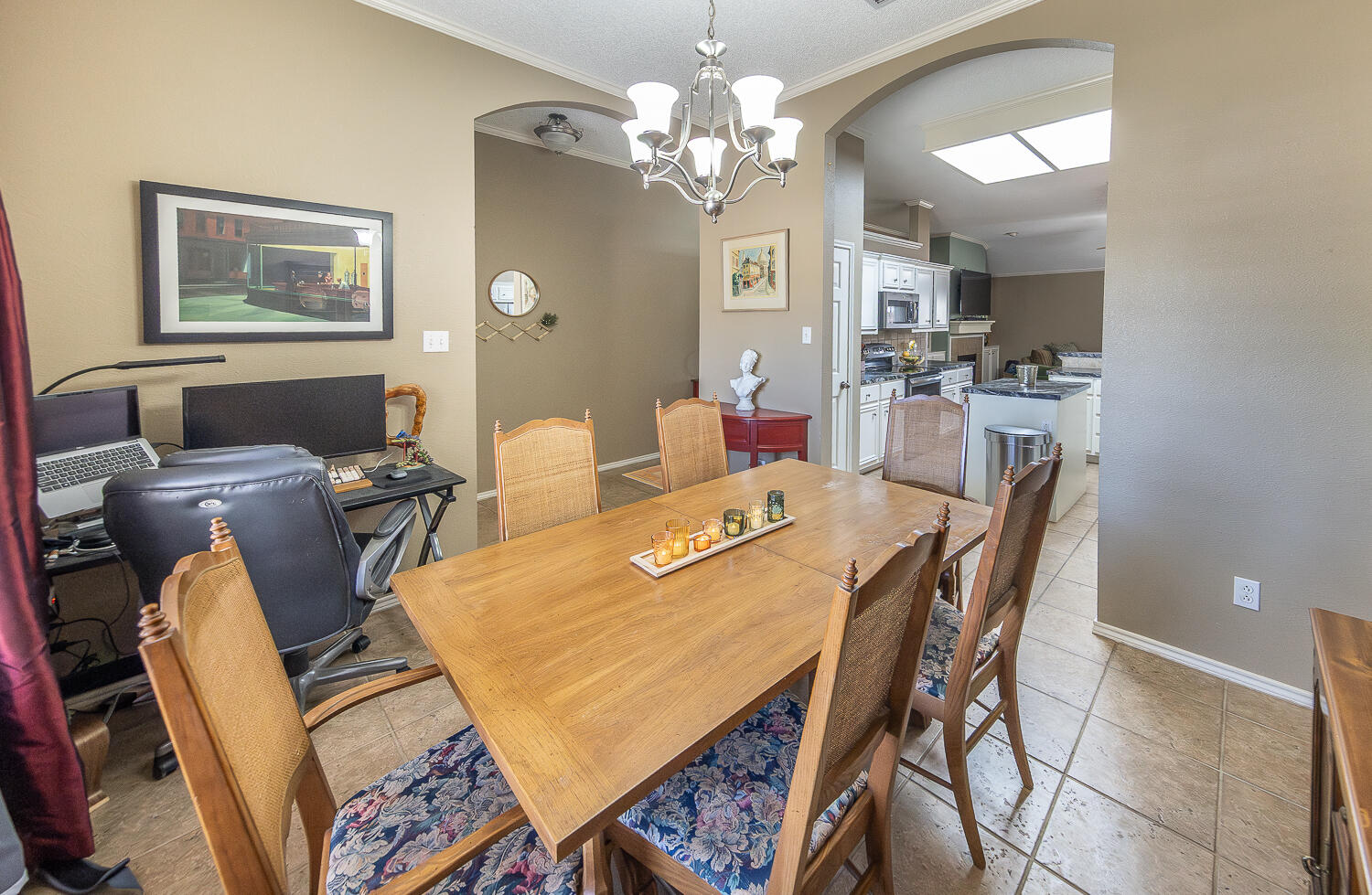 6901 9th Street Lubbock, TX 79416 - Photo 22 of 27 a view of a dining room with furniture and a chandelier