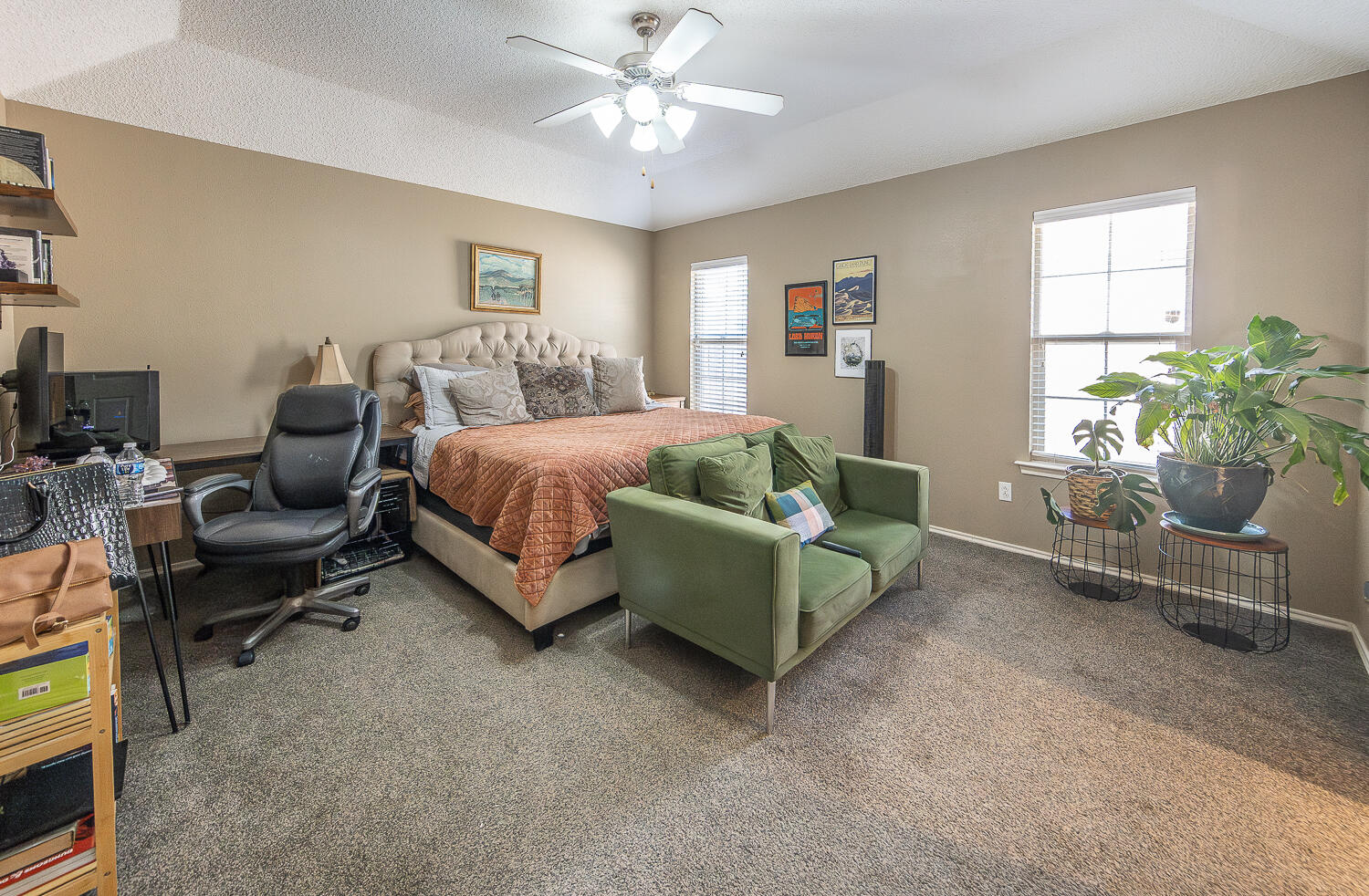 6901 9th Street Lubbock, TX 79416 - Photo 23 of 27 a spacious bedroom with a bed and a couch