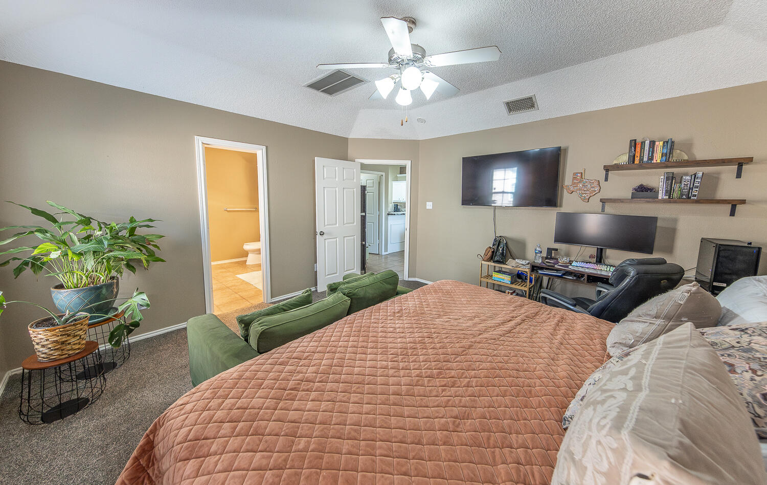 6901 9th Street Lubbock, TX 79416 - Photo 25 of 27 a bedroom with bed and a chandelier